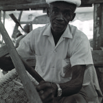 Jewell Allen, of Whiteville, weaving a chair seat with cornhusks at the Smithsonian Festival of American Folklife.  Photo by Robert Cogswell, 1986.
