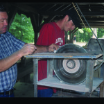 John Bickerstaff and Eric Strong shape flint marbles at the National Rolley Hole Tournament.  Photo by Robert Cogswell, 2001.