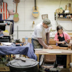 Luthier Manuel Delgado observes Ava Delgado, apprentice, at work in January 2018 on a custom mandolin, at the Delgado Guitars shop in Nashville