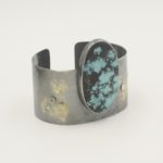 Fused Lichen Wide Turquoise Cuff
Sterling Silver and fused 18 kt gold with Chinese turquoise oval and blue diamond accent, 3 x 2.5 x 2.5 inches