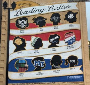 A mural titled Leading Ladies shows nine female silhouettes with icons and phrases like Be Bold, Help and Heal, Raise Your Voice, and Show Up. At the bottom is a quote by Alice Duer Miller.