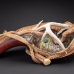 Pine needle coiling with sea grass band on a gourd, embraced with shed antlers, mica lined with turquoise, leather and peacock feather, 10 x 26 x 14 inches