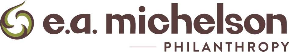 The logo for e.a. michelson philanthropy features stylized brown text with a green abstract swirl design on the left and the word “PHILANTHROPY” in uppercase below the main name.